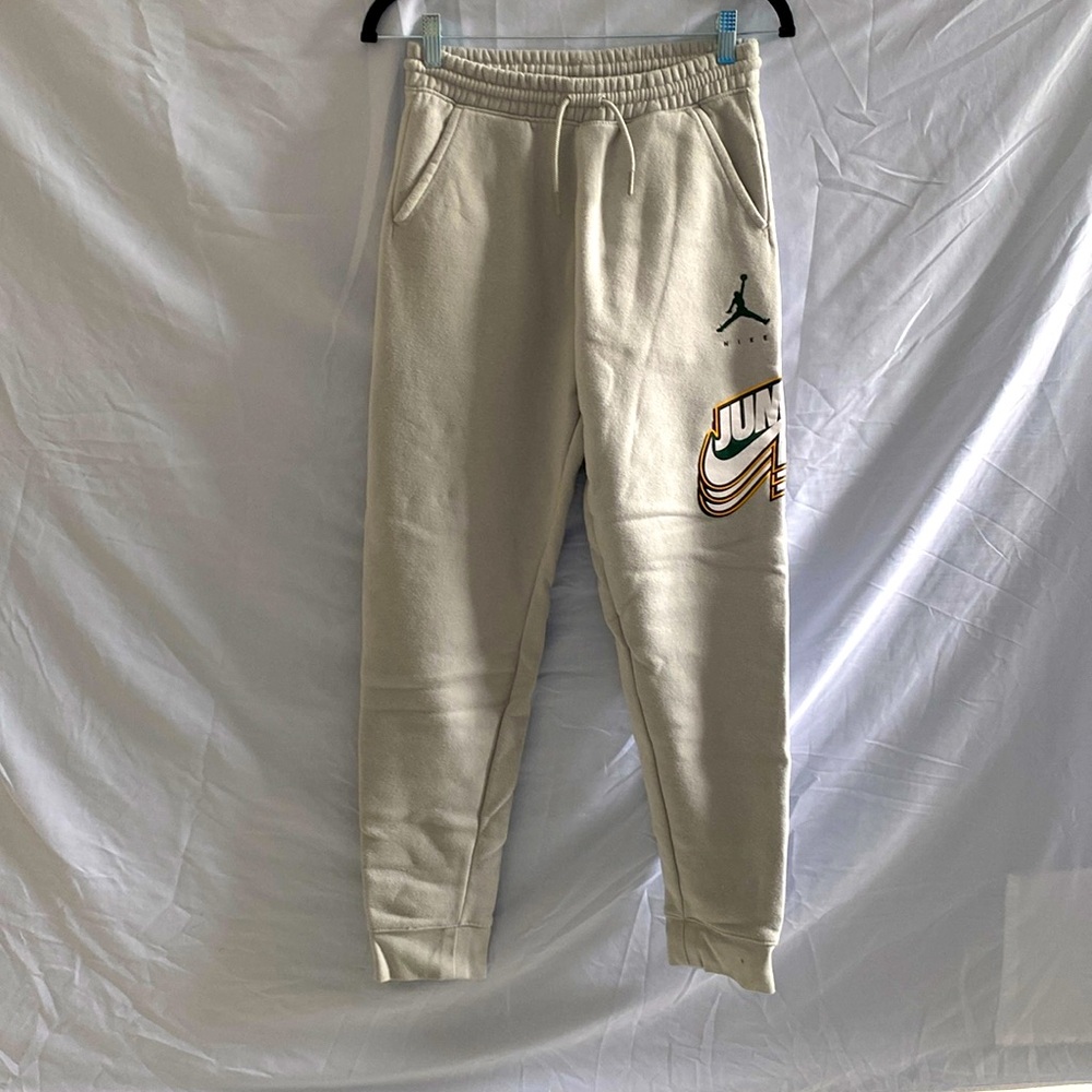 Cream colored Nike jump man sweatpants
